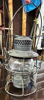 Front angled view of entire lantern showing globe, cage and handle