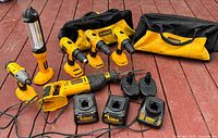 All DeWalt tools, chargers, batteries and bags laid out on deck