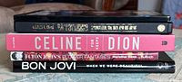 Stack of five hardcover photobooks with spines visible