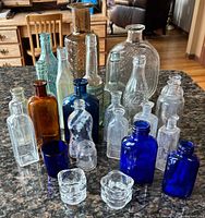 Front view of entire lot showing variety of bottle shapes, sizes and colors