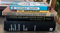 Stack of five books showing spines and titles