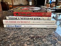 All five hardcover books stacked showing spines