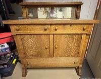 Front view showing buffet, mirror, drawers, cabinet doors