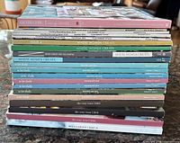 Full stack of 18 magazine spines showing titles and issue count