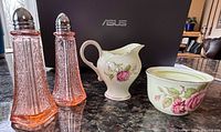 Full lot showing pair pink glass shakers, bone china creamer and sugar bowl