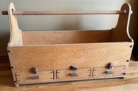 Front view showing three drawers closed, handle, overall construction