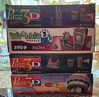 Stacked view of four puzzle boxes showing titles and piece counts