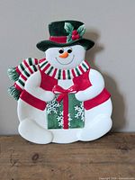 Front view of ceramic snowman platter with festive colors
