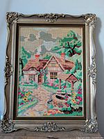 Full view of framed cross-stitch tapestry