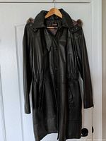 Front view of olive green leather coat on hanger