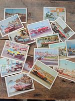 Fronts of assorted drag racing trading cards spread on table