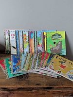 Full lot of 29 Little Golden hardcover books displayed on table