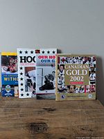 All four hockey books standing on wooden surface