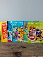 Six hardcover books standing upright showing spines and partial covers