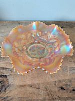 Top view of marigold carnival glass bowl showing ruffled edge and strawberry pattern