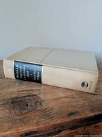 Spine view of beige cloth hardcover with black title label and World Publishing logo