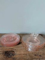 Stack of two plate designs: round ribbed and square handled, showing quantity and style