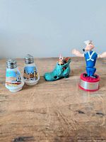 Group overview showing Popeye figure, two milk glass shakers and shoe planter