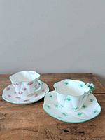 Two teacup and saucer sets displayed