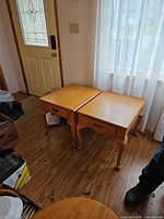 Pair of wooden end tables side by side showing tops and front view with drawers closed