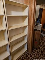 Front view showing five shelves and white laminate finish