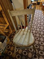 Front view of worn wooden chair with spindle back