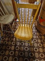 Full view of wooden chair standing upright