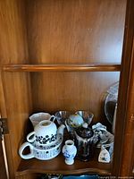 Lower shelf with tea-for-one set, dessert bowls, coffeepot and small decorative pieces