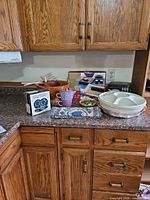 Overview showing boxed items, purple tea set, wooden bowls, serving tray