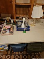 Wide shot of entire lot on table including bookends, vases, lamp and gift set