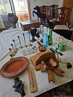 Full table view showing all decorative items including candle holders, horse silhouette, vases, wooden pieces and plate