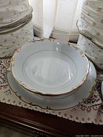 serving bowl and underplate showing gold trim