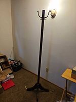 Full view of wood coat tree showing overall design and height