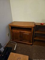 Front view of stand with closed doors and open shelf