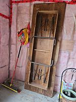 underside showing metal folding legs and wood construction