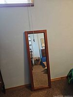 Front view showing full mirror and wood frame