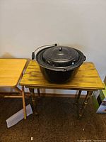 Overall view of enamel canning pot with lid on table
