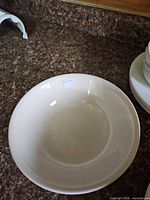 white deep soup bowl with sticker