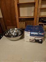 Boxed Waring Pro yogurt maker beside nested stainless steel bowls