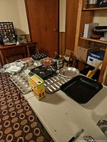 overview of table with roasters, double boiler, muffin-top, snack cake and pie plates