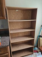 Front view showing five fixed shelves and hole in back panel