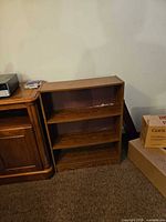 Front view of small brown 3-shelf bookcase