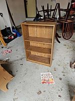 Front view showing three shelves, woodgrain finish