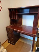 Front view of dark wood computer desk with hutch