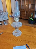 Full view of oil lamp standing on table