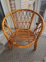 Barrel-back rattan armchair front view
