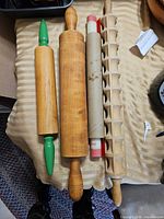 Three wooden rolling pins on table