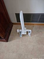 Side view of bathtub safety handle showing clamp mechanism