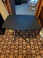 Black folding tray table folded open