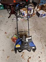 Full view of Snow Joe electric snow thrower showing body, chute and handle